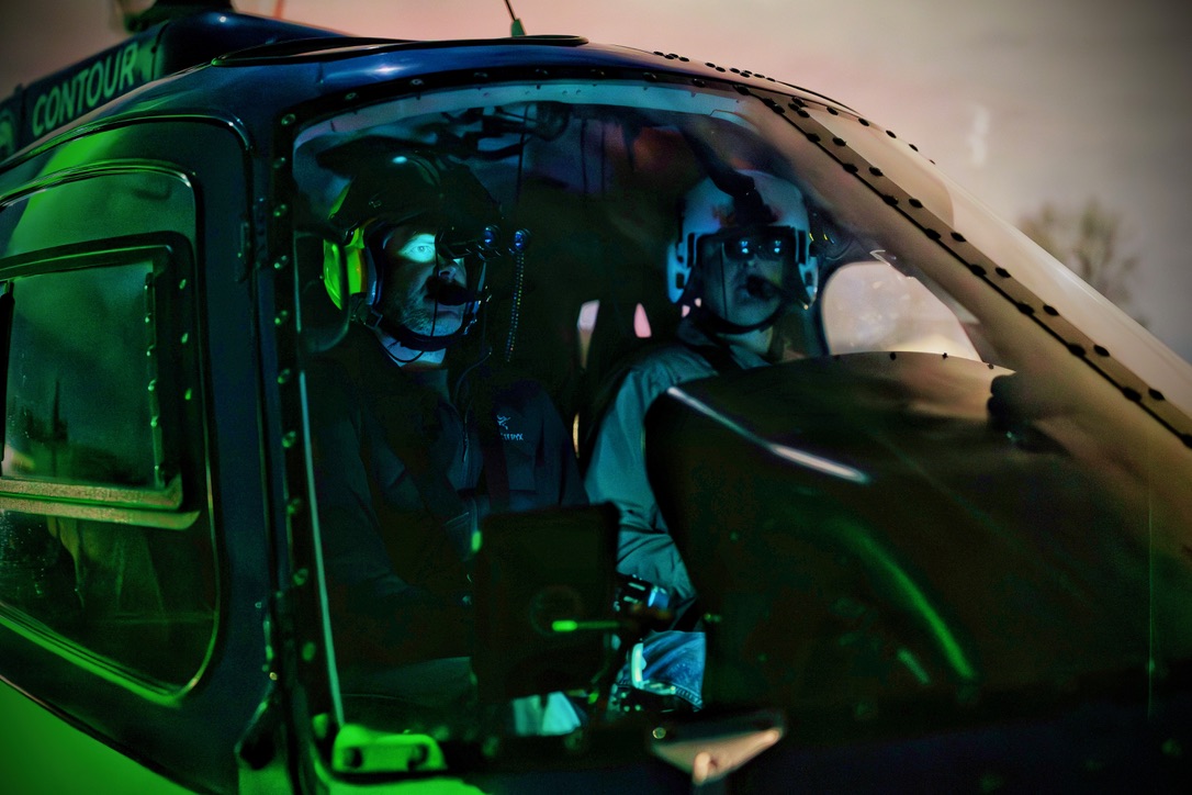 NVG night training — two pilots under green cockpit light