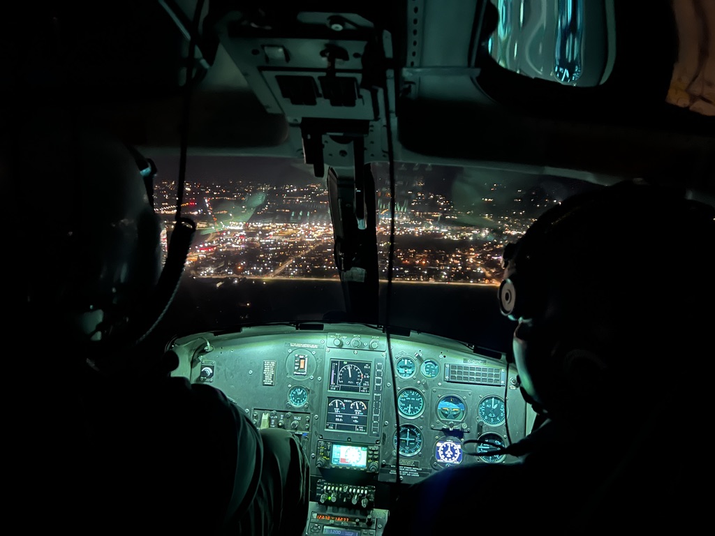 Night cockpit over city lights — NVG training